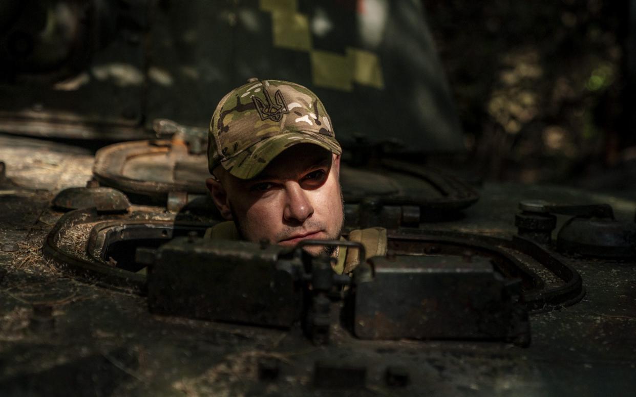 A Ukrainian soldier prepares a 2C3 tank at their fighting position in Donetsk Oblast