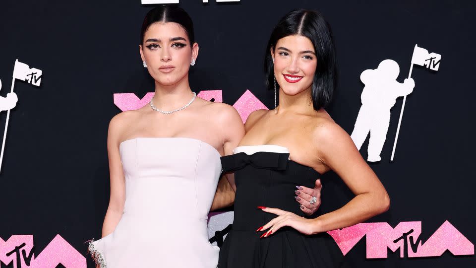 TikTok stars Dixie and Charli D'Amelio were a contrasting and complementary pair, with Dixie (left) in a white strapless Maticevski mermaid dress and Charli (right) in a black dress with playful white trim. - Andrew Kelly/Reuters