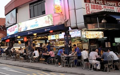 Singaporeans wear singlets, shorts and slippers in Holland Village to protest a caller's rant. (Yahoo! photo)