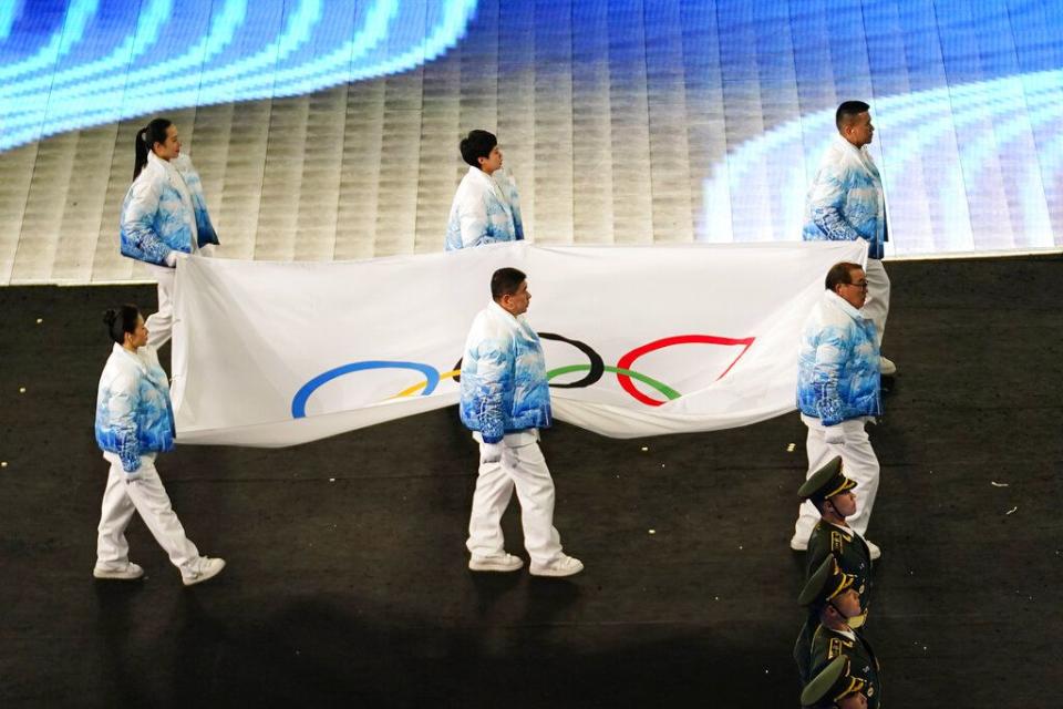 The Olympic flag is carried into the stadium during the opening ceremony of the 2022 Winter Olympics, Friday, Feb. 4, 2022, in Beijing. (AP Photo/Matt Slocum)