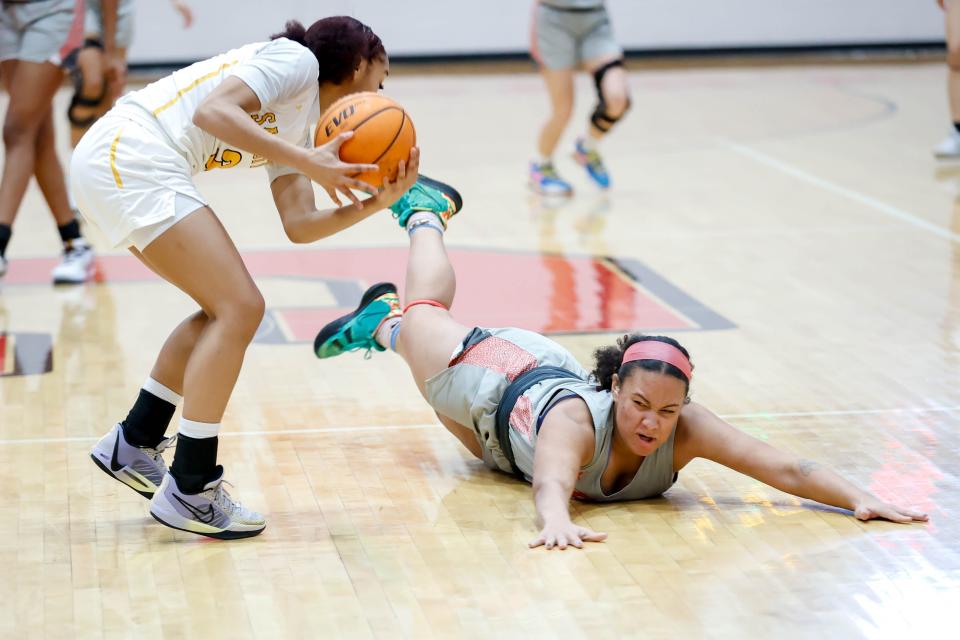 Carl Albert’s Ausha Moore (24) dives for the ball in possession by Sand Springs’ Taiona Morris (3) during the Titan Classic tournament between Carl Albert and Sand Springs in Midwest City, Okla., on Saturday, Jan. 20, 2024.