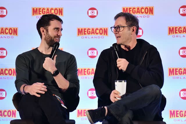 <p>Gerardo Mora/Getty</p> Matthew Lewis (L) and Jason Isaacs speak during a Q&A session at MegaCon Orlando 2024 at Orange County Convention Center on February 04, 2024 in Orlando, Florida.