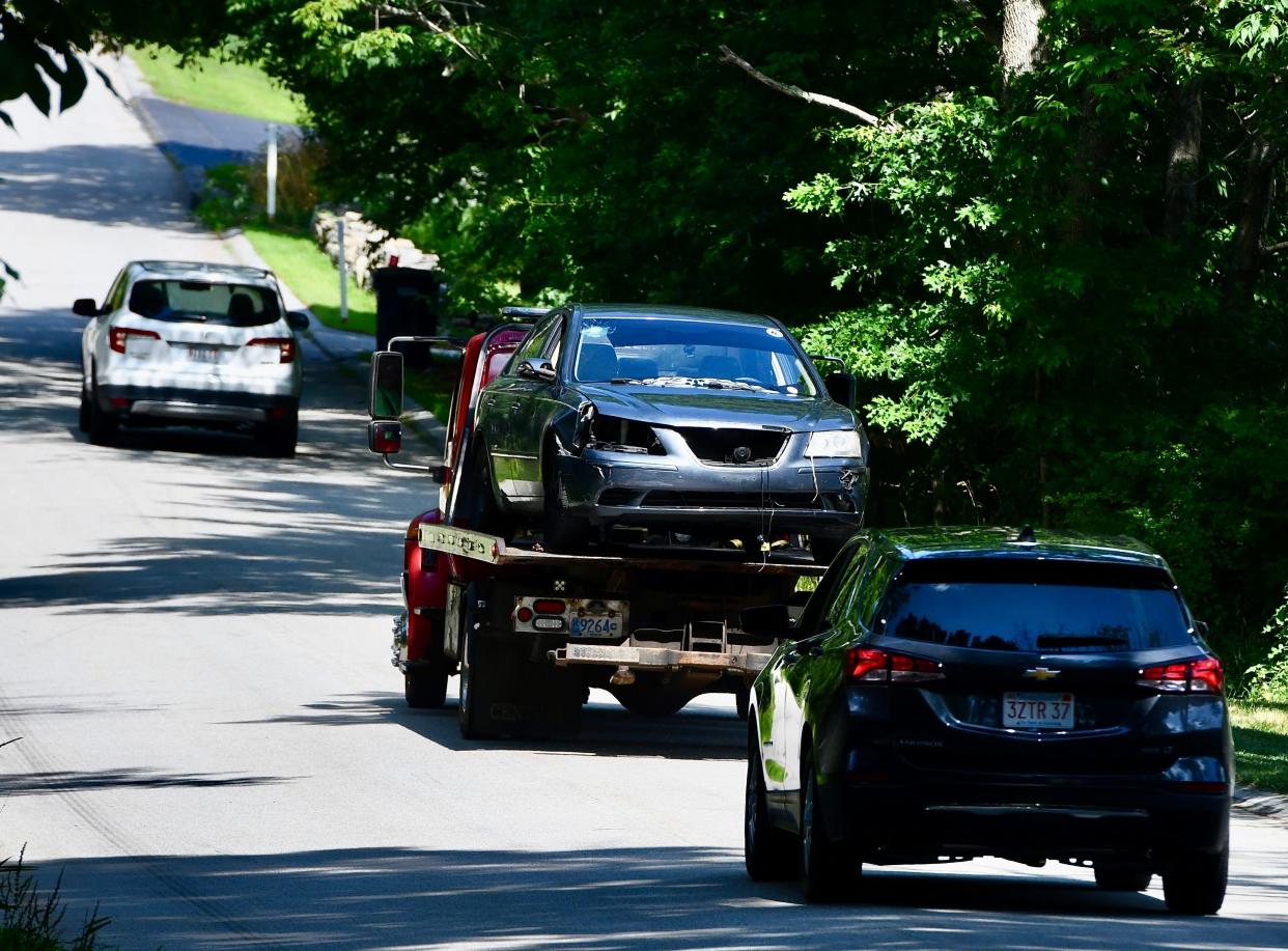 A car that was involved in a high- and low-speed chase with several police departments is towed away from Torrey Road in Southbridge on Thursday.