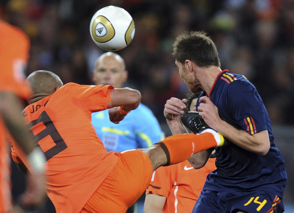 FILE - In this Sunday, July 11, 2010, file photo, Netherlands' Nigel de Jong, left, fouls Spain's Xabi Alonso during the World Cup final soccer match between the Netherlands and Spain at Soccer City in Johannesburg, South Africa. Violence is part of the game in many sports. But when the Cleveland’s Myles Garrett ripped the helmet off Mason Rudolph and hit the Pittsburgh Steelers’ quarterback in the head with it, the Browns’ defender crossed a line _ one that attracts the attention of authorities sometimes from within their sport and in other cases from criminal prosecutors. (AP Photo/Daniel Ochoa de Olza, File)
