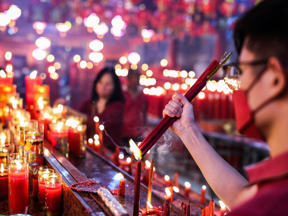 A man light incense as he pray for good fortune on the first day of the Lunar New Year at Hok Lay Kiong temple in Bekasi, West Java Province, Indonesia, on January 22, 2023.