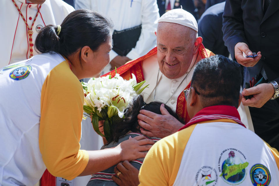 Pope Francis is welcomed as he arrives at the Centro de Conven??es in Díli, East Timor, Wednesday, Sept. 11, 2024, for a meeting with young people. The Vatican says some 600,000 people have attended Pope Francis' Mass in East Timor, or nearly half the country's population, on Tuesday on the same field where St. John Paul II prayed in 1989 during the nation's fight for independence from Indonesia. (AP Photo/Gregorio Borgia)