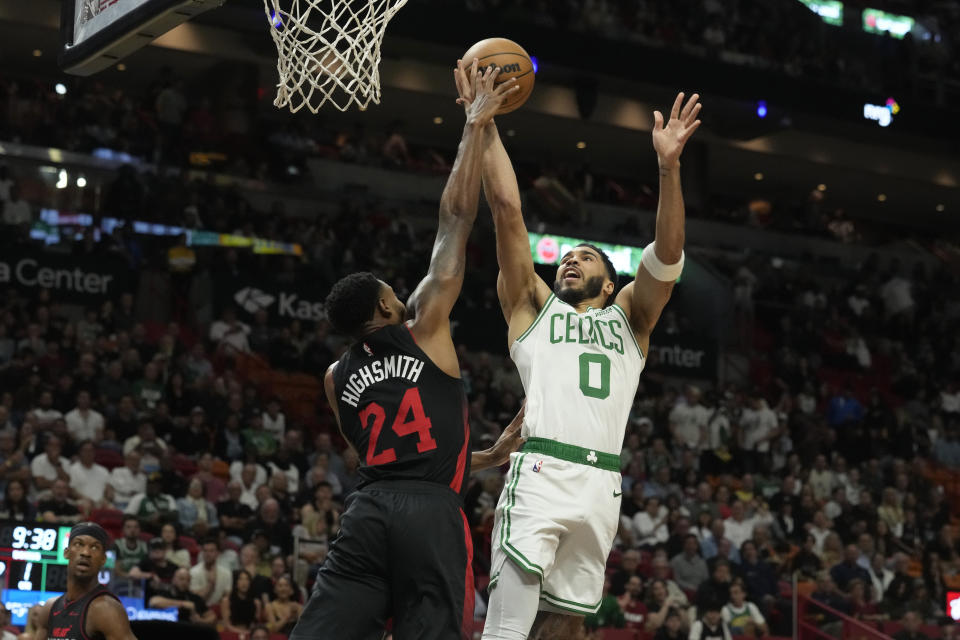 Boston Celtics forward Jayson Tatum (0) drives to the basket as Miami Heat forward Haywood Highsmith (24) defends during the first half of an NBA basketball game, Thursday, Jan. 25, 2024, in Miami. (AP Photo/Marta Lavandier)