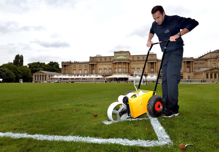 Karl Standley marks out a football pitch in the gardens of Buckingham Palace in London on Thursday. Two of England's oldest amateur clubs will play in the grounds of the official London home of Queen Elizabeth II next month as part of the English Football Association's 150th anniversary celebrations