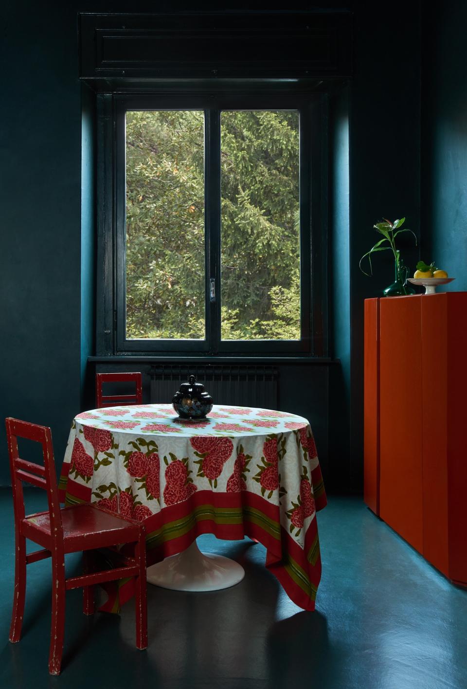 A round table with patterned tablecloth