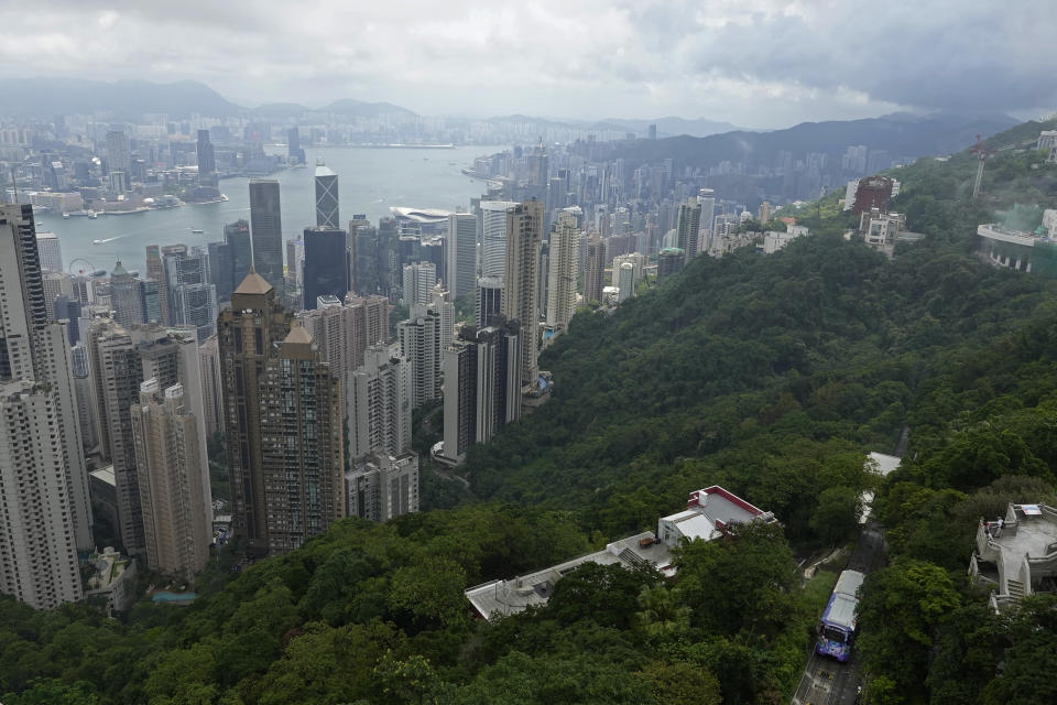 A Peak Tram passes an uphill of the Victoria Peak with a backdrop of Hong Kong on June 17, 2021. Hong Kong’s Peak Tram is a fixture in the memories of many residents and tourists, ferrying passengers up Victoria Peak for a bird’s eye view of the city’s many skyscrapers. (AP Photo/Vincent Yu)