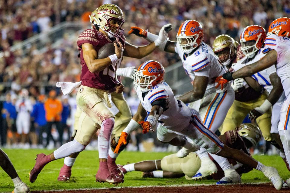 Florida State Seminoles quarterback Jordan Travis (13) scores a touchdown. The Florida State Seminoles defeated the Florida Gators 45-38 at Doak Campbell Stadium on Friday, Nov. 25, 2022.