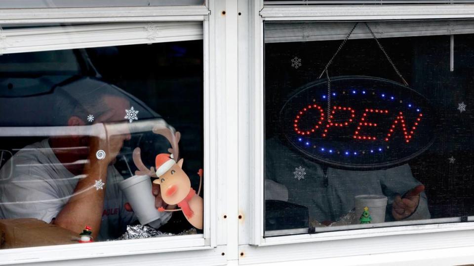 Customers eat at Stubbs & Son BBQ in Carthage, N.C., Wednesday, Dec. 7, 2022. Power was restored to many parts of Moore County on Wednesday.