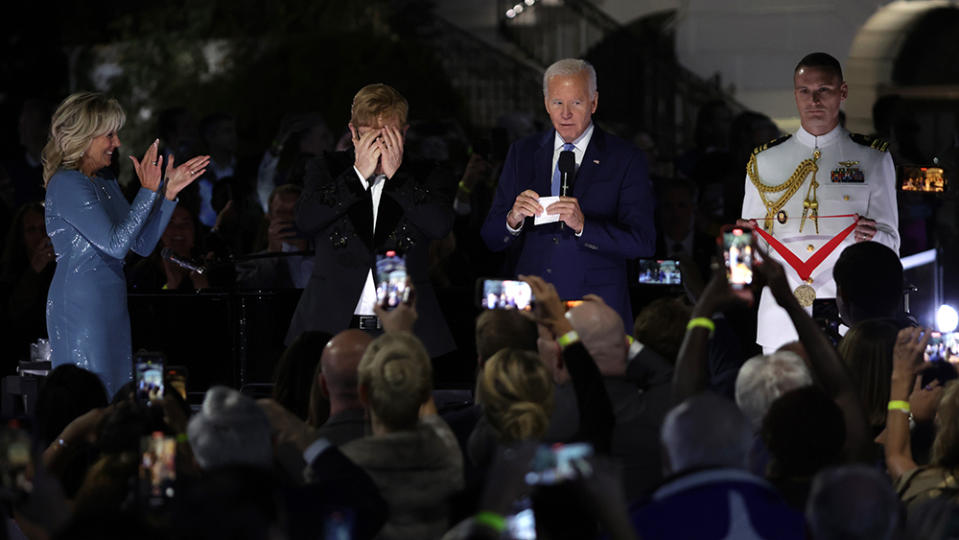 WASHINGTON, DC - SEPTEMBER 23: British singer-songwriter Sir Elton John (2nd L) reacts as U.S. President Joe Biden (3rd ) announces that he will be presented with the National Humanities Medal as first lady Jill Biden (L) looks on during an event at the South Lawn of the White House on September 23, 2022 in Washington, DC. President Joe Biden and first lady Jill Biden hosted the event titled “A Night When Hope and History Rhyme,” to “celebrate the unifying and healing power of music, commend the life and work of Sir Elton John, and honor the everyday history-makers in the audience, including teachers, nurses, frontline workers, mental health advocates, students, LGBTQ+ advocates and more.” (Photo by Alex Wong/Getty Images)