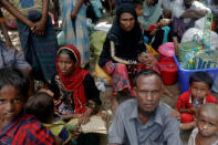 Rohingya refugees who arrived by boat fleeing violence in Myanmar the night before, wait to receive some aid at a relief centre at Teknaf near Cox's Bazar, Bangladesh October 4, 2017. REUTERS/Damir Sagolj
