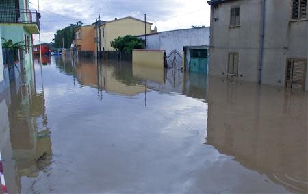 A flooded street is pictured in San Gavino Monreale on Sardina island November 18, 2013. REUTERS/Rosaspress