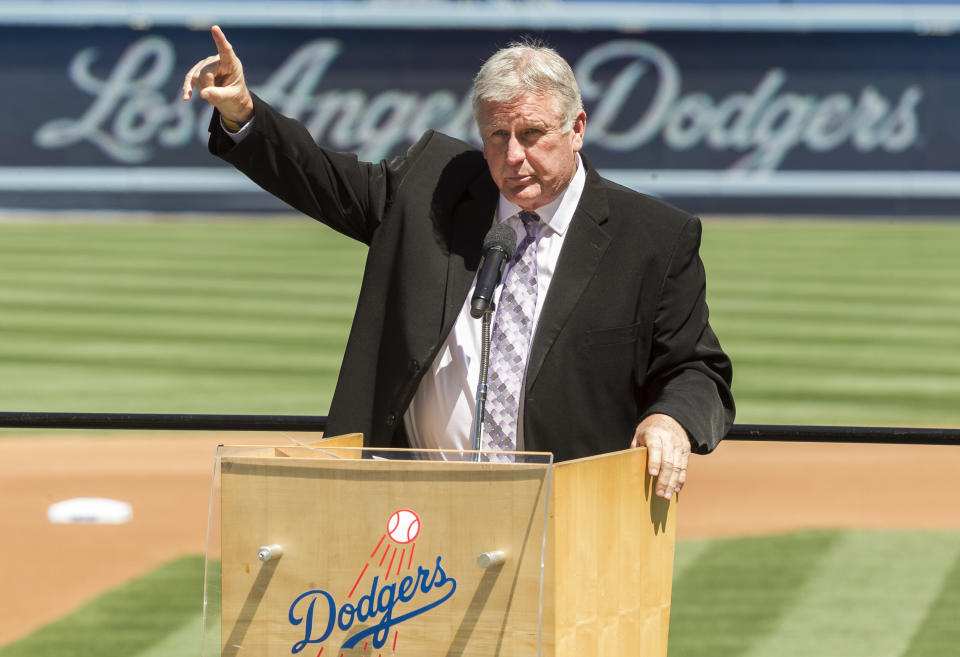 THS DELETES ANY REFERENCE TO TOMMY JOHN BEING A COVID DENIER - FILE - In this April 7, 2014, file photo, former Los Angeles Dodgers pitcher Tommy John praises his late friend, Dr. Frank Jobe, during a memorial service at Dodger Stadium in Los Angeles. Jobe pioneered the elbow procedure that became known as Tommy John surgery. Tommy John has been battling COVID-19 for at least three weeks. The 77-year-old former pitching great remains hospitalized near his home in Indio, California. He said he started to feel ill following a trip to Nashville before he was hospitalized on Wednesday, Jan. 6, 2021. (AP Photo/Damian Dovarganes, File)