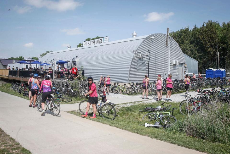 Cyclists pull into the Flat Tire Lounge in Madrid for refreshments.