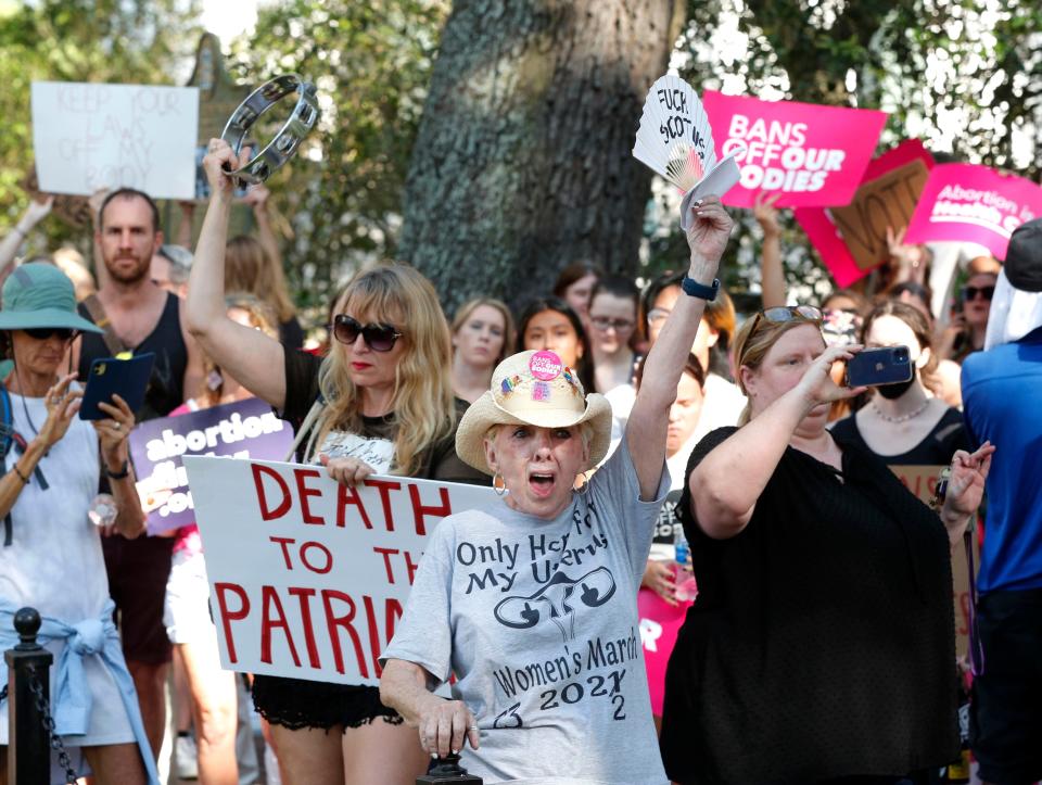 Participants cheer and chant during a reproductive rights rally  June 24 in Johnson Square in Savannah. The rally was held in response to the Supreme Court's decision to overturn Roe v. Wade.