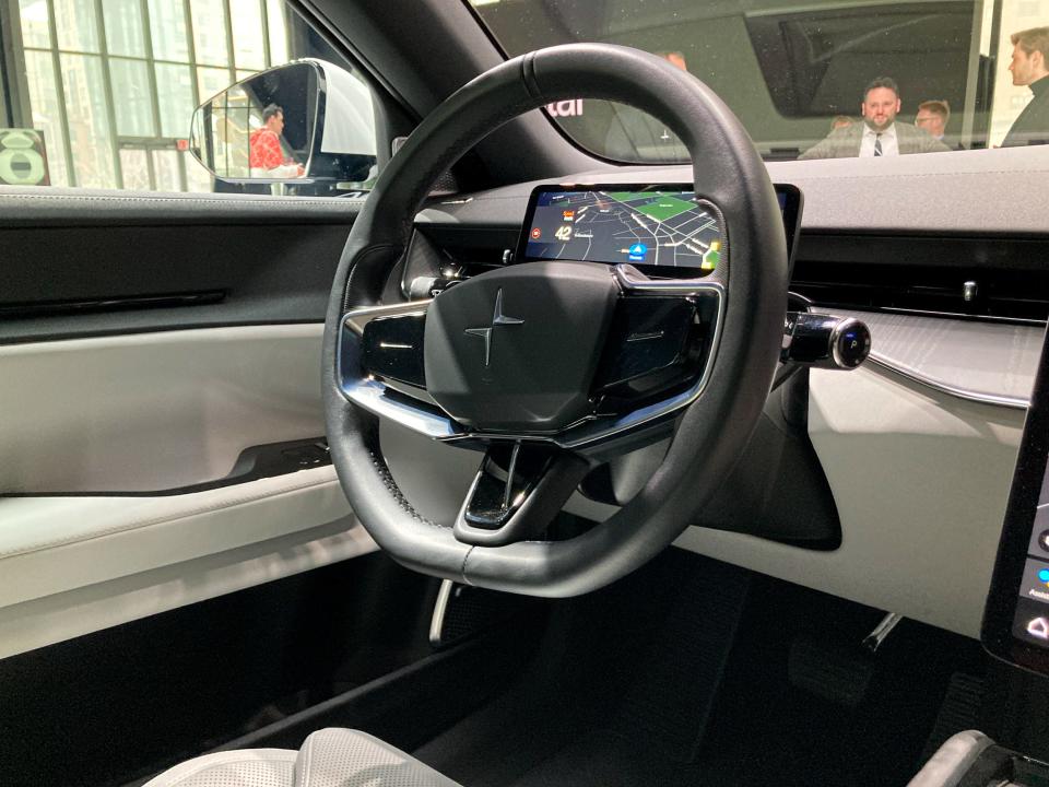 The steering wheel in the Polestar 3 electric SUV, with a small display behind.