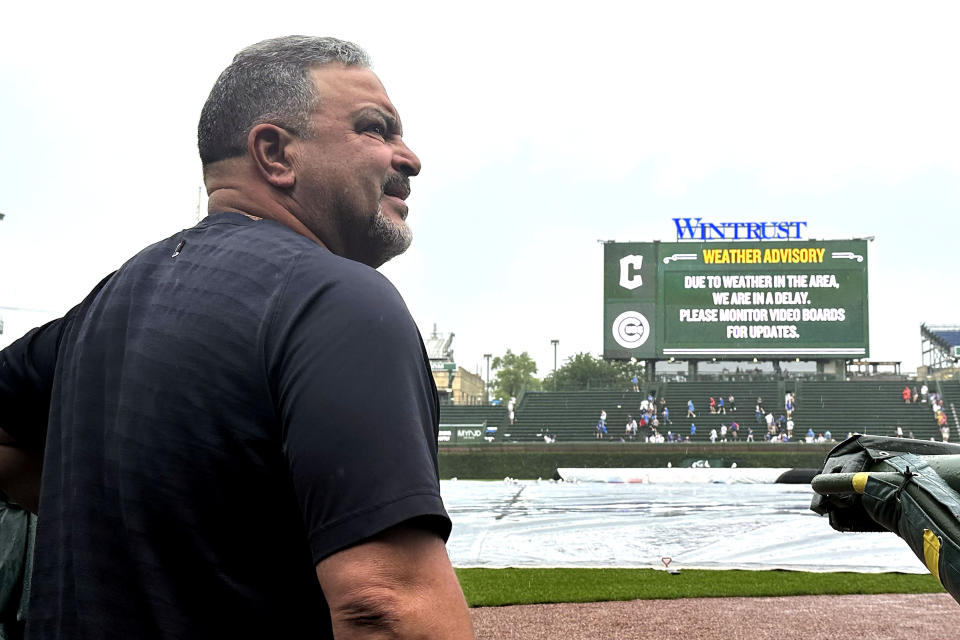 Cleveland Guardians assistant hitting coach Victor Rodríguez looks out from the dugout during a weather delay before a baseball game against the Chicago Cubs, Saturday, July 1, 2023, in Chicago. (AP Photo/Charles Rex Arbogast)