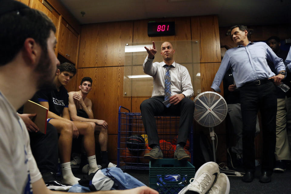 Head coach Elliot Steinmetz talks to the Yeshiva University Maccabees in the locker room after they beat U.S. Merchant Marine Academy, 75-57, Tuesday, Feb. 25, 2020. (AP Photo/Jessie Wardarski)