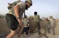 <p>Afghan troops and soldiers with the US Army’s 1-320 Field Artillery Regiment, 101st Airborne Division take up fighting positions after taking incoming fire at Combat Outpost Nolen in the Arghandab Valley north of Kandahar, on July 27, 2010. (Photo: Bob Strong/Reuters) </p>