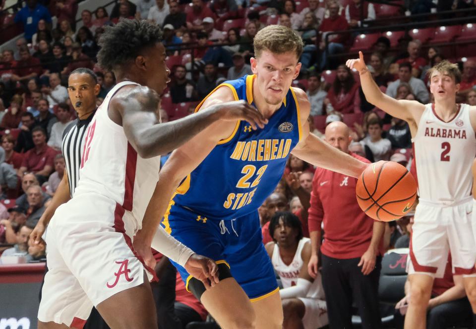 Nov 6, 2023; Tuscaloosa, Alabama, USA; Morehead State guard Riley Minix (22) drives against Alabama guard Latrell Wrightsell Jr. (12) at Coleman Coliseum. Mandatory Credit: Gary Cosby Jr.-USA TODAY Sports