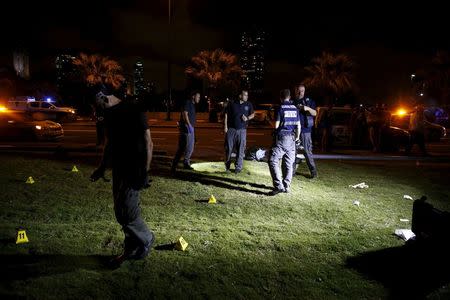 Israeli police search the spot where, according to Israeli police spokesperson, at least 10 Israelis were stabbed, in the popular Jaffa port area of Tel Aviv, Israel March 8, 2016. REUTERS/Amir Cohen