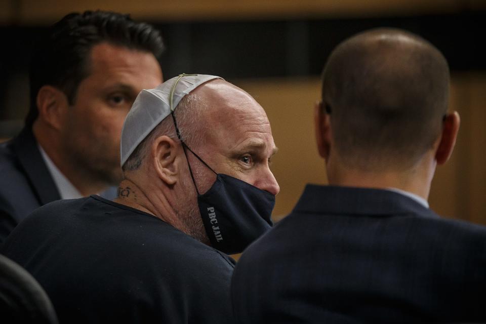 Joseph Hamilton, center, charged with the first-degree murder of Nicolas Lampp, talks with his public defenders during a hearing at the Palm Beach County Courthouse in West Palm Beach on Aug. 8.
