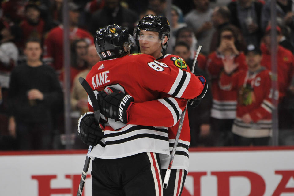 Chicago Blackhawks' Patrick Kane (88) celebrates with teammate Dominick Kubalik (8) of the Czech Republic, after defeating the San Jose Sharks 6-2 in an NHL hockey game Wednesday, March 11, 2020, in Chicago. (AP Photo/Paul Beaty)