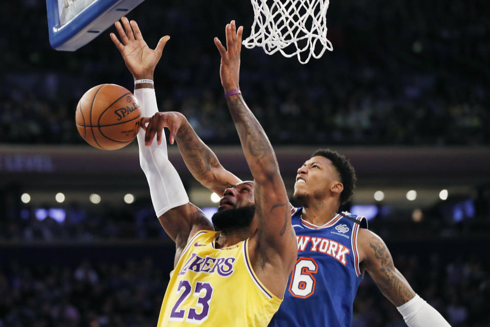 New York Knicks guard Elfrid Payton (6) tips the ball away from Los Angeles Lakers forward LeBron James (23) during the first half of an NBA basketball game in New York, Wednesday, Jan. 22, 2020. (AP Photo/Kathy Willens)