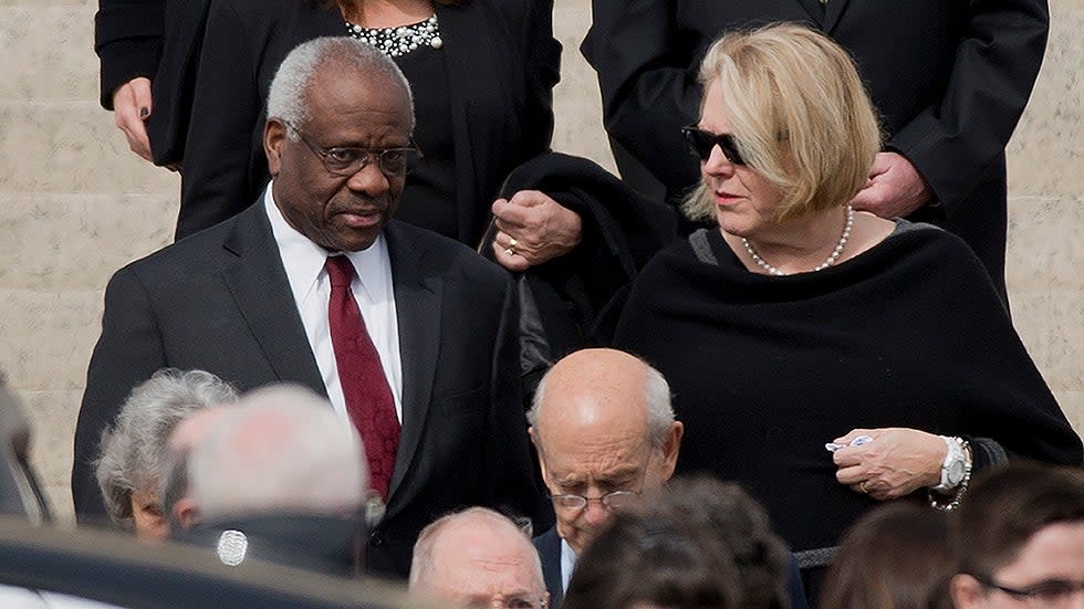 Supreme Court Justice Clarence Thomas, left and his wife Virginia Thomas, right, leave the funeral services of the late Supreme Court Associate Justice Antonin Scalia, on Feb. 20, 2016.