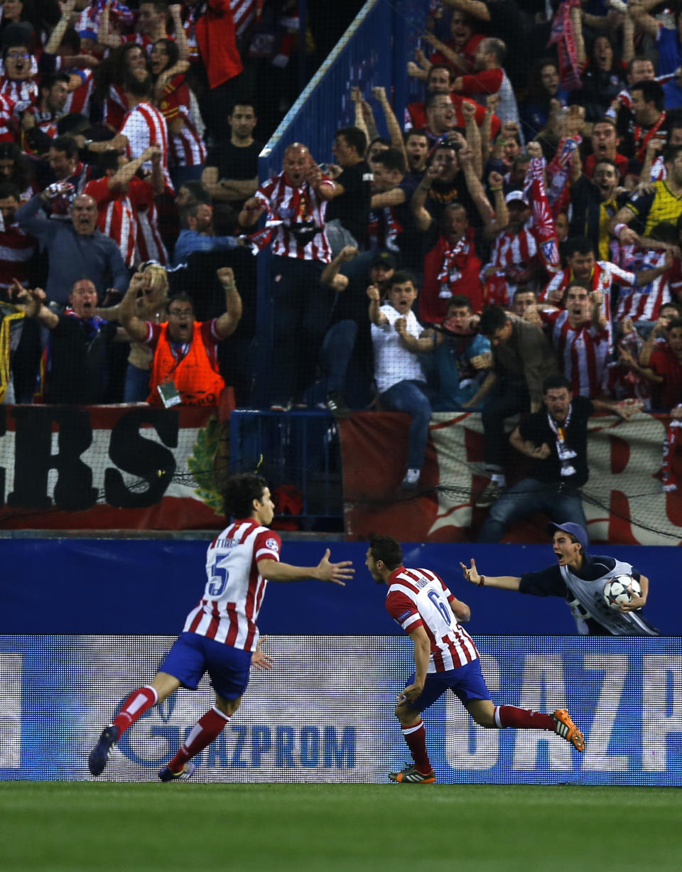 Atletico's Koke celebrates after scoring the opening goal with teammate Tiago, left, during the Champions League quarterfinal second leg soccer match between Atletico Madrid and FC Barcelona at the Vicente Calderon stadium in Madrid, Spain, Wednesday, April 9, 2014. (AP Photo/Andres Kudacki)