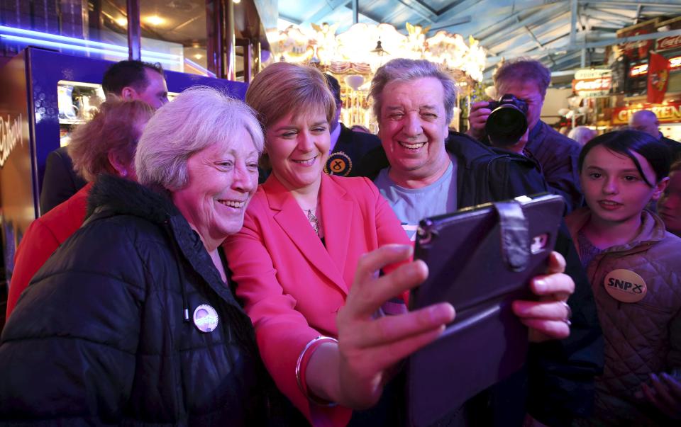 First Minister for Scotland Nicola Sturgeon takes a selfie with supporters during a campaign visit to a theme Park, Motherwell, central Scotland