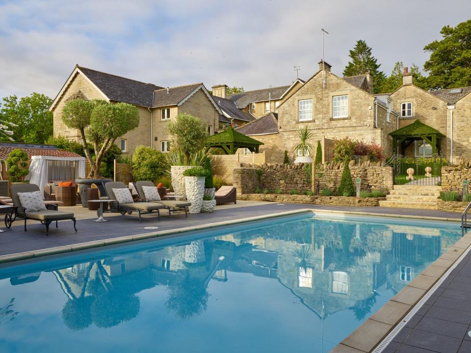 <p>This eclectic country house hotel in Bath has a refreshing outdoor pool in its 20 acres of rolling West Country grounds. Ideal for when the temperature rises, <a href="https://www.booking.com/hotel/gb/homewood-park.en-gb.html?aid=2200763&label=hotels-outdoor-pools" rel="nofollow noopener" target="_blank" data-ylk="slk:Homewood;elm:context_link;itc:0;sec:content-canvas" class="link ">Homewood</a>'s outdoor heated swimming pool is the perfect place to unwind, with cabanas, comfy sun loungers and topiary setting the scene. </p><p>For guests who are here to make use of the wellness offerings, a dip in the pool can be combined with a soak in the adjacent hot tub, a swim in the indoor hydrotherapy pool, and some relaxation in the sauna or steam room.</p><p>If all that leaves you feeling peckish, the Olio Restaurant is the place to go for simple yet beautifully presented food, made with locally sourced produce.</p><p><a class="link " href="https://www.booking.com/hotel/gb/homewood-park.en-gb.html?aid=2200763&label=hotels-outdoor-pools" rel="nofollow noopener" target="_blank" data-ylk="slk:BOOK NOW;elm:context_link;itc:0;sec:content-canvas">BOOK NOW</a></p>