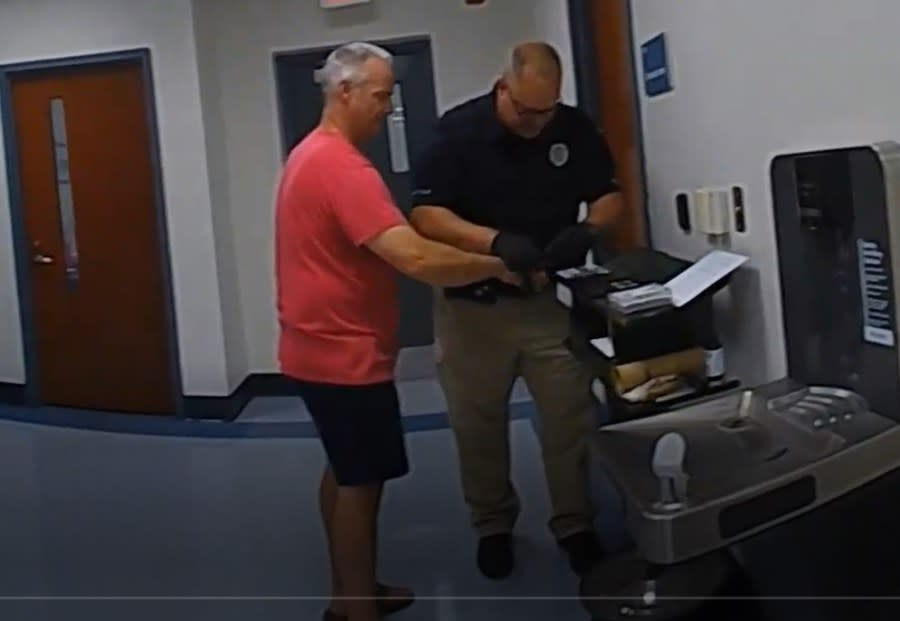 Robert Waters getting fingerprinted. (Courtesy)