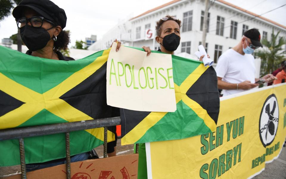 People calling for slavery reparations protest outside the entrance of the British High Commission during the visit of the Duke and Duchess of Cambridge in Kingston on March 22 - RICARDO MAKYN/AFP