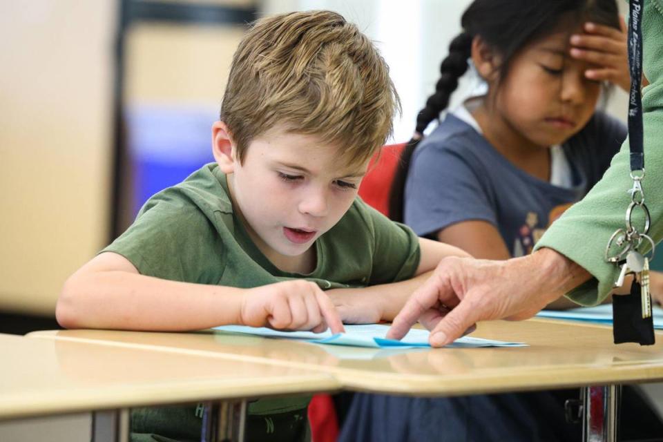 First-graders Oliver Hootman and Evan Jimenez Flores practice reading word by word at Carrisa Plains Elementary School.