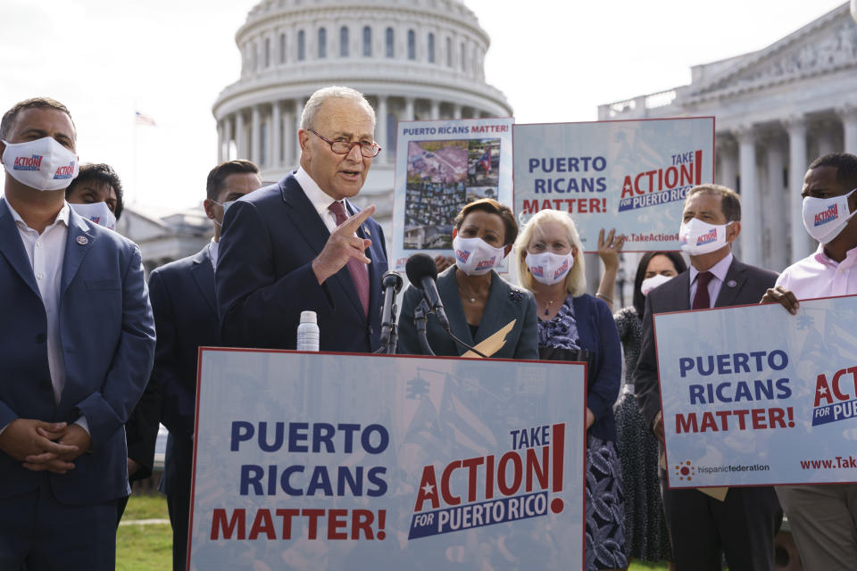 Senate Majority Leader Chuck Schumer, D-N.Y., joins advocates for Puerto Rico, which still suffers from the effects of Hurricane Maria in 2017, at the Capitol in Washington, Monday, Sept. 20, 2021. Schumer said it was "extremely disappointing" that the Senate's nonpartisan parliamentarian ruled Democrats can't use their $3.5 trillion package bolstering social and climate programs to give millions of immigrants a chance to become citizens. (AP Photo/J. Scott Applewhite)