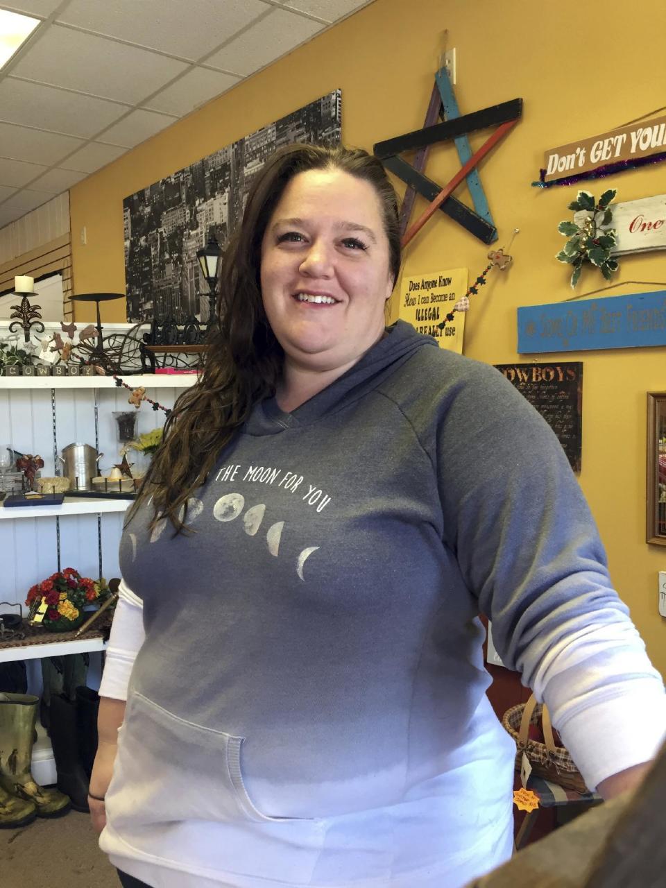 In this Dec. 13, 2016 photo, Shay Chamberlain poses for a picture in her small clothing store and boutique in Menomonie, Wis. As each Cabinet announcement draws fresh criticism of Donald Trump's latest appointees, many Americans who voted for him, like Chamberlain, say the president-elect is doing what he promised to do: draining the swamp. (AP Photo/Amy Forliti)