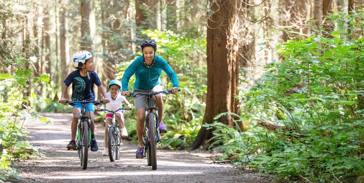 mom and kids race on bikes