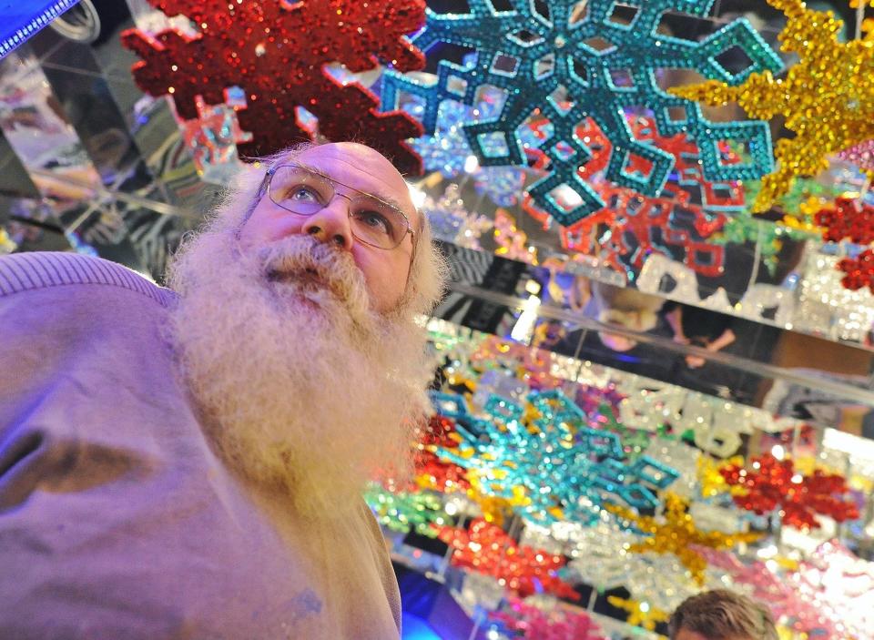 Mark Klaus stands in his Infinity Room, which is filled with NYC Bloomingdale's window displays, at Castle Noel Christmas museum in Medina.