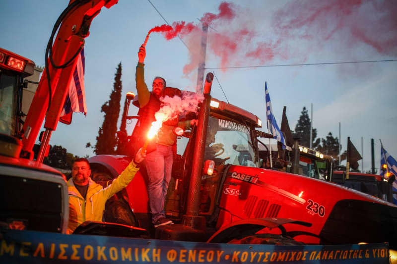 Farmers stand on their tractors in front of the Greek parliament during a demonstration in the center of Athens. Socrates Baltagiannis/