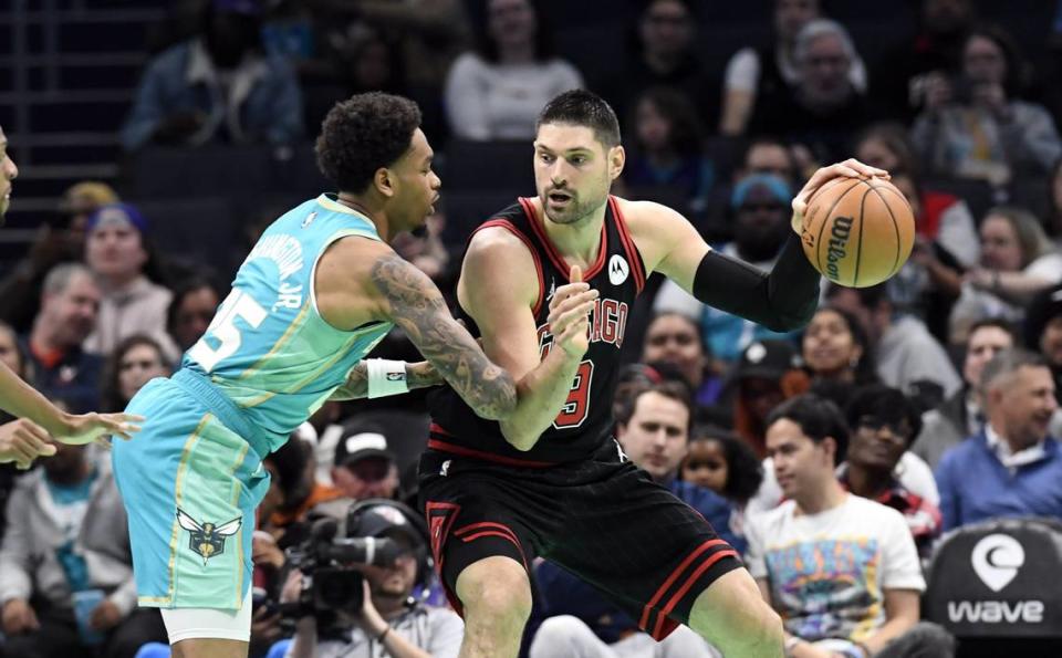 Chicago Bulls center Nikola Vucevic (9) looks to drive in as he is defended by Charlotte Hornets forward P.J. Washington (25) during the first half at the Spectrum Center.