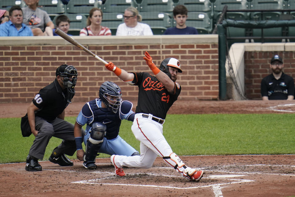 Baltimore Orioles' DJ Stewart follows through as he hits a solo home run off Toronto Blue Jays starting pitcher Alek Manoah during the fourth inning of a baseball game, Saturday, June 19, 2021, in Baltimore. (AP Photo/Julio Cortez)