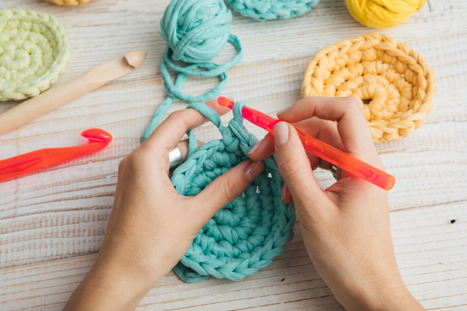 Hand made hobby crafts things. woman hands knitting crochet.  Top view. Horizontal composition