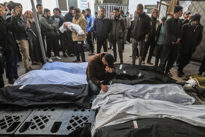 Palestinians mourn their relatives, who were killed amid the Israeli attacks, at Al-Najjar Hospital. Mohammed Talatene/dpa