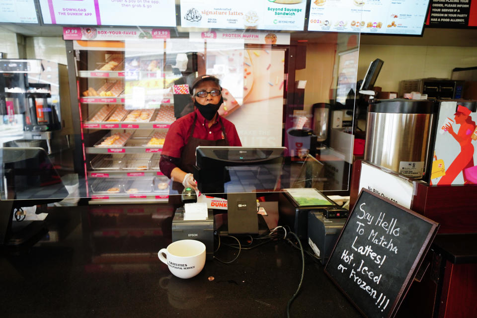 A view of a Dunkin' Donuts cashier protected by a plastic partition as anti-COVID-19 measure in Flushing Queens New York USA during coronavirus pandemic on April 16, 2020.  (Photo by John Nacion/NurPhoto via Getty Images)