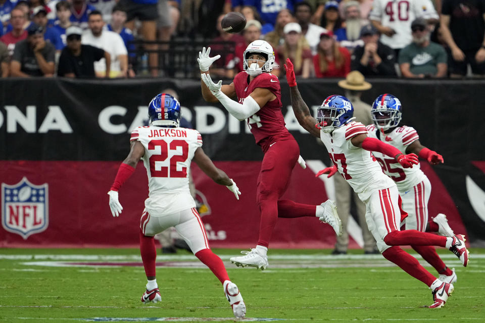 Arizona Cardinals wide receiver Michael Wilson (14) makes a catch over New York Giants safety Jason Pinnock (27) during the first half of an NFL football game, Sunday, Sept. 17, 2023, in Glendale, Ariz. (AP Photo/Matt York)