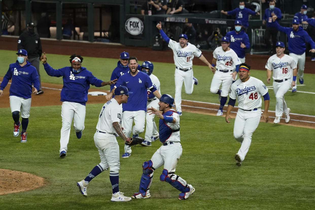 The Dodgers rush the field after defeating the Rays to win the World Series.